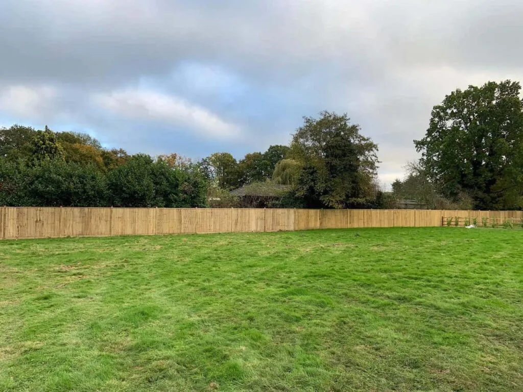 This is a photo of feather edge fencing installed around the edge of a field by Fast Fix Fencing Ashford