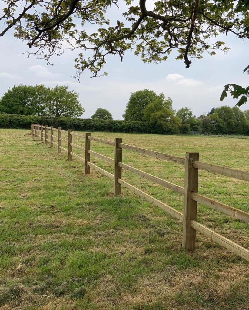 This is a photo of a post and rail fence installed in a field by Fast Fix Fencing Ashford
